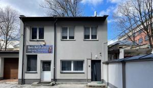 a white building with a sign on the front of it at Apartamenty Przy Deptaku w Radomiu in Radom