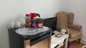 a table with food and drinks on top of a tv at Spacious Double Room in Anfield in Liverpool +22 photos