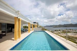 a swimming pool on the balcony of a house at Airport View 3-Bed Villa in Cupecoy