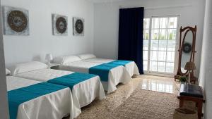 1 dormitorio con 2 camas y ventana grande en Villa Mis 5 Amores con piscina en Benidorm
