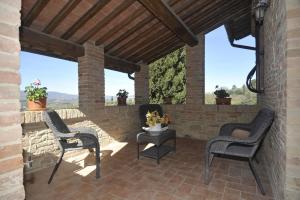 a patio with two chairs and a table at Villa Alice in Chiusi