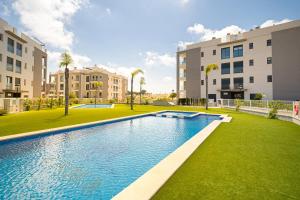 an image of a swimming pool in front of some buildings at Valentino in Orihuela Costa