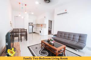 a living room with a couch and a table at I-City Homestay@5 min walk to shopping Mall in Shah Alam