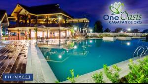 a resort with a swimming pool at night at Kate's Corner @ One oasis Condo in Cagayan de Oro