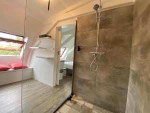 a bathroom with a shower with a glass door at Casa Coral - a hidden gem for families in Groningen