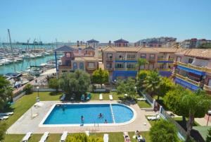 an overhead view of a swimming pool next to a harbor at Marina Sunrise Puerto in Torrevieja