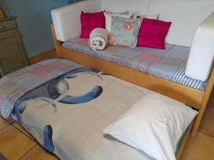 a bed with two bunk beds with pillows at Casa da Adega in Machico