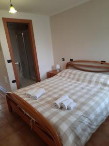 a bedroom with a bed with two towels on it at Bed & Breakfast Castello Regina in Brembilla