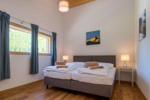 Ένα ή περισσότερα κρεβάτια σε δωμάτιο στο Montela Apartments by fewo-plan SAAS220