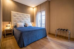 Säng eller sängar i ett rum på Hotel Rialto