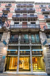 a facade of a building with windows and balconies at Hotel Rialto in Barcelona