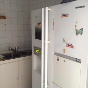 a refrigerator in a kitchen with magnets on it at CIT Y Khadra in Tunis