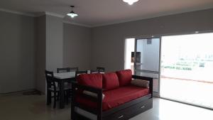 a living room with a red couch and a table at A7A - Apartamento de 2 dormitorios con Terraza y Asador in Santiago del Estero