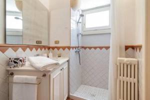 a white bathroom with a shower and a sink at Dimora Santangelo in Lecce