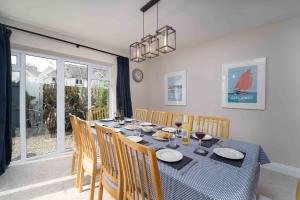 a dining room with a table with chairs and a dining room at Merlins in Hayle