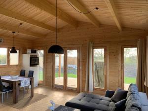 a living room with a couch and a table at Ferienhaus Tollensesee in Groß Nemerow