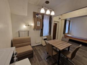 a small living room with a table and a couch at Bem Downtown Apartment in Debrecen