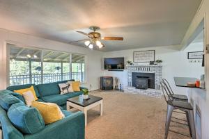 a living room with a blue couch and a fireplace at Spacious Jackson Home with Grill and Mtn Views! in Jackson