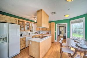 a kitchen with a white refrigerator and a table at Amazing Musical Abode in Expo Square Neighborhood! in Tulsa