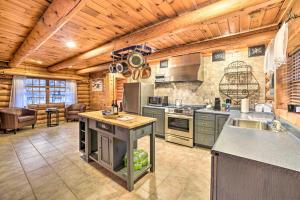 a large kitchen with wooden ceilings andsteel appliances at Spacious Cabin with Decks Near Saratoga Springs in Middle Grove