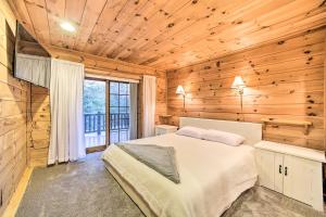 a bedroom with a bed in a wooden cabin at Spacious Cabin with Decks Near Saratoga Springs in Middle Grove