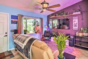 a living room with a couch and a ceiling fan at Updated Fort Myers Escape with Screened Lanai! in Fort Myers