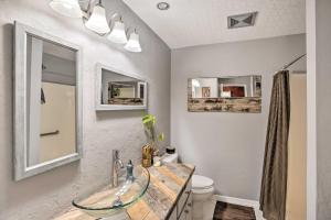 a bathroom with a glass sink and a toilet at Updated Fort Myers Escape with Screened Lanai! in Fort Myers +19 photos