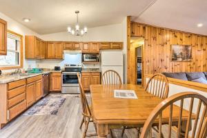 a kitchen and dining room with a wooden table at Charming Marion Cabin Fire Pit and Mtn Views! in Marion