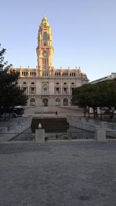 a building with a clock tower on top of it at Casa do Largo in Porto