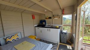 a small kitchen in a tiny house with a table at Cae Mawr Yurt Off-Grid Glamping in Machynlleth