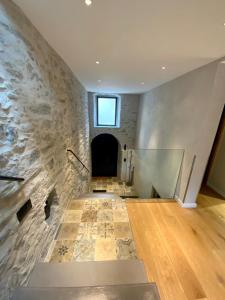 a room with a stone wall with a window at Superbe maison dans village au coeur de la Corse A casa Suttana in Verdese +70 photos
