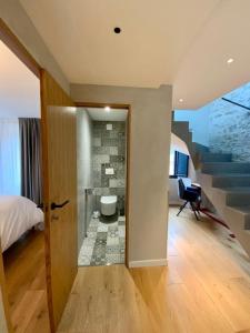 a bedroom with a staircase and a room with a bed at Superbe maison dans village au coeur de la Corse A casa Suttana in Verdese