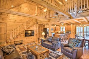 a living room with leather furniture in a log cabin at Charming Cabin with Deck, 10 Min to Bretton Woods! in Carroll