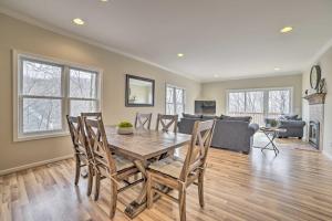 a dining room and living room with a table and chairs at Pet-Friendly Home with Hot Tub and Pool Access! in Harbor Springs