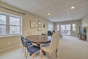a dining room with a wooden table and chairs at Pet-Friendly Home with Hot Tub and Pool Access! in Harbor Springs