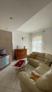 uma sala de estar com um sofá e uma televisão em Appartamento Canalotto 65 2 piano em Realmonte