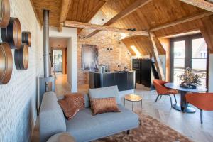 a living room with a couch and a kitchen at Luxe appartementen Havenzicht in Sint Annaland