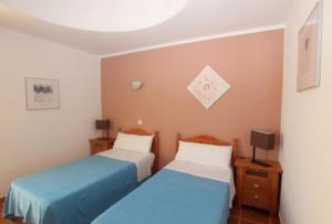 dwa łóżka w pokoju z niebieskim i białym w obiekcie Villa con piscina, vistas, dunas, mar, 6 personas w Corralejo