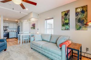 a living room with a blue couch and a kitchen at Ogunquit Beach Lookout in Ogunquit