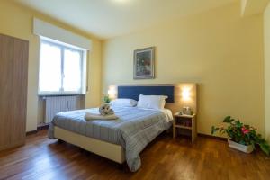 a bedroom with a bed with a teddy bear on it at La Pineta - Le Casette di Osvaldo in Lecco
