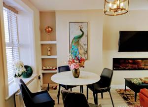 a living room with a table and a peacock painting at Tralee Townhouse Holiday Home in Tralee