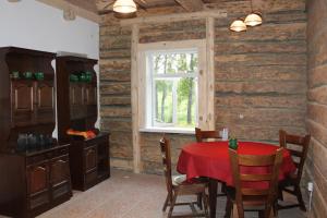 a dining room with a table and a window at Zirgu sēta "Klajumi" - Horse ranch "Klajumi" in Kaplava