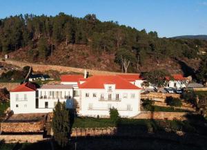 a large white house with a red roof at Quinta da Rocha 1875 in Pedrógão Pequeno