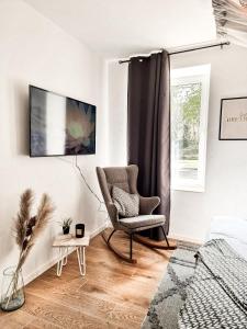 a living room with a chair and a window at Holiday Home Amélie in Bollendorf