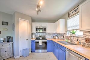 a kitchen with blue cabinets and a sink at Home with Game Room and Hot Tub, 1 Mi to SeaWorld in San Antonio