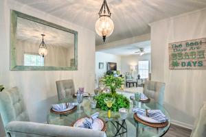 a dining room with a glass table and chairs at Charming Bluffton Escape with Patio and Gas Grill in Bluffton