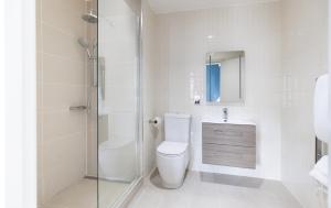 a white bathroom with a toilet and a shower at Native Edinburgh in Edinburgh