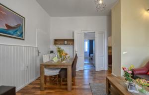 a dining room and living room with a wooden table at City Apartment TODOR in Pula