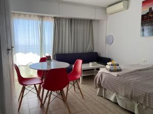 a bedroom with a table and chairs next to a bed at Apartamento 29th floor & sea view in Alicante