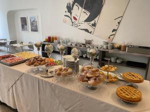 una mesa con muchos tipos diferentes de comida en ella en Hotel Castellino Roma, en Roma